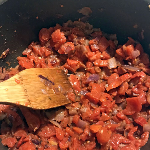 stirring tomatoes